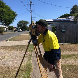 Man surveying residential property.